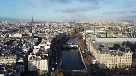 Drone-flying-over-the-River-Seine-in-Paris,-with-the-Eifel-Tower-in-the-background-on-the-left-side