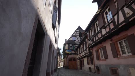 Empty-street-in-Kaysersberg,-with-ukrainian-flag-hanging-from-half-timbered-house