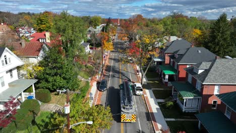 Fire-truck-driving-in-USA-town-during-autumn