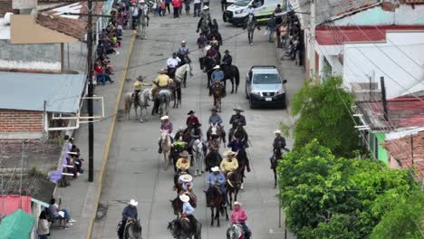 Aerial-view-showing-horses-on-street-during-Mariachi-Festival-in-Tecalitlan-City,-Mexico