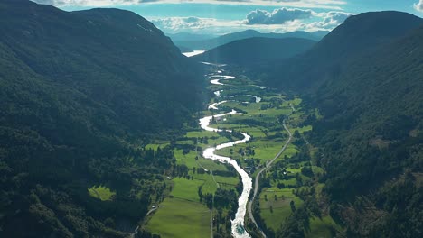 Flight-over-the-Stryneelva-river-with-its'-many-turns-winds-through-the-lush-green-Strynedalen-valley-in-Norway
