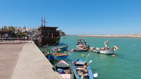 Colorful-boats-on-Rabat's-river-embankment,-clear-Moroccan-skies