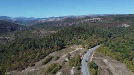 4K-Drone-Footage-Captures-Cars-Journeying-Through-a-Picturesque-Countryside-Forest-Road-near-Birtvisi-Canyon-in-Kvemo-Kartli,-Georgia