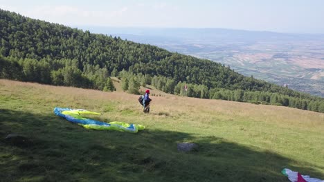 Athlete-paraglider-waiting-for-the-wind-to-get-stronger-to-fly