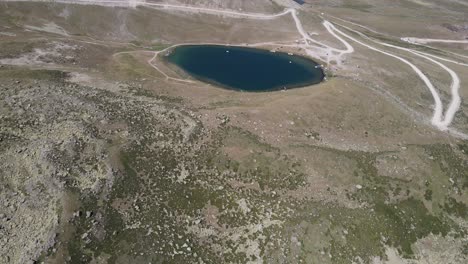 Aerial-view-of-a-small-lake-at-the-top-of-the-mountain,-a-naturally-formed-lake,-in-Turkey