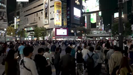 Busy-Crowds-Walking-Across-Iconic-Shibuya-Crossing-In-The-Evening