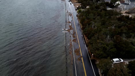 Drone-Footage-showing-cars-driving-the-rising-Floodwaters-waves-breach-cedar-beach-road-on-January-10th