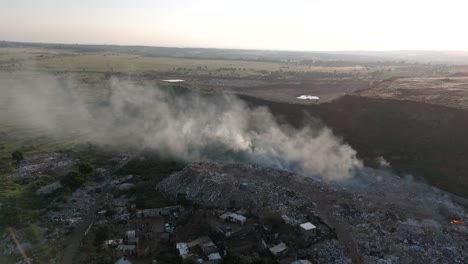 A-static-drone-shot-captures-the-coexistence-of-a-rural-township-village-and-a-waste-processing-plant-in-South-Africa