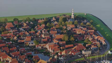 Aerial-drone-view-of-small-village-with-orange-roofs,-Hindeloopen,-Friesland