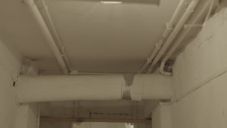 Overhead-pipes-on-a-white-ceiling-in-disrepair
