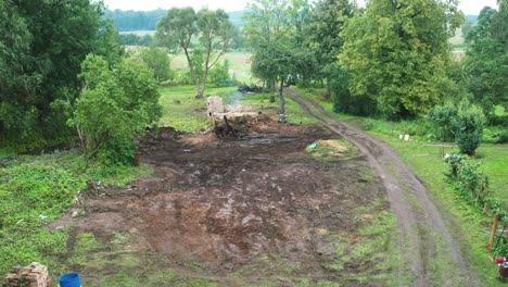 Aerial-view-of-cleaned-countryside-yard,-fresh-dirt-ground-after-removing-trash