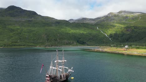 Pirate-Ship-and-Dramatic-Nature-Landscape-in-Lofoten-Islands,-Norway---Aerial-4k