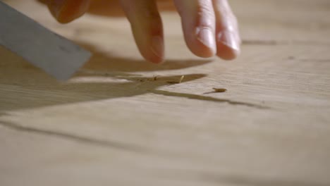 An-artisan-carves-a-piece-of-wood-manually