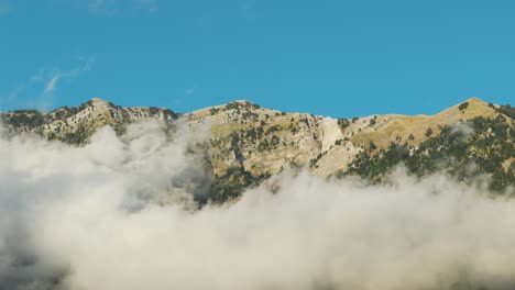 Aerial-view-of-Albanian-mountain-range-and-white-clouds-near-foothill
