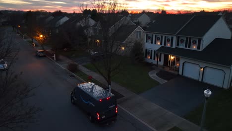 Amazon-delivery-van-stopped-at-house-decorated-for-Christmas-during-sunset