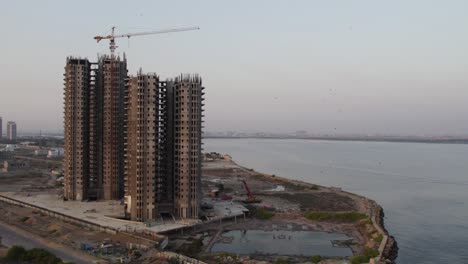 Skyscrapers-under-construction-by-the-sea-at-dawn