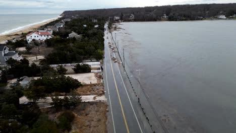 Drone-Footage-showing-cars-driving-the-rising-Floodwaters-waves-breach-cedar-beach-road-on-January-10th