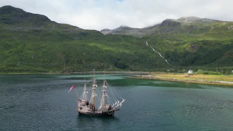 Pirate-Ship-and-Dramatic-Nature-Landscape-in-Lofoten-Islands,-Norway---Aerial-4k-Circling