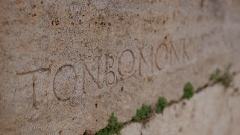 Close-up-of-Greek-text-written-in-a-stone-in-Hierapolis