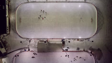 Overhead-view-of-outdoor-hockey-rinks-at-night,-4K
