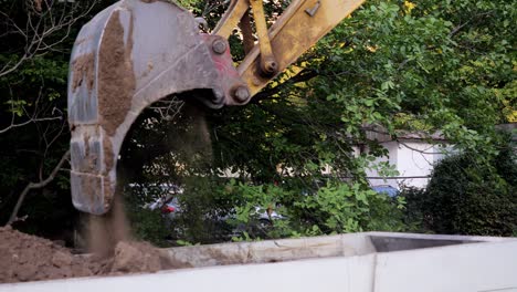 -Slow-motion-of-an-excavator-dumps-soil-into-a-truck