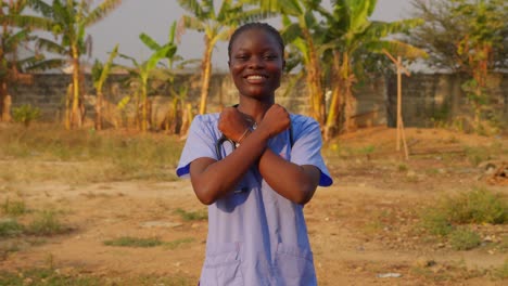 africa-female-nurse-doctor-saying-I-love-you-with-gesture-sign-language-in-front-of-camera-happily-smiling