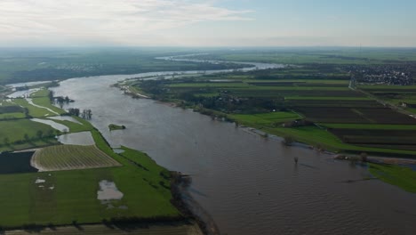 Aerial-wide-shot-of-the-Lek-River-in-that-Netherlands,-that-has-swelled-to-more-than-five-time-its-normal-size-as-heavy-rains-inundate-much-of-Northern-Europe