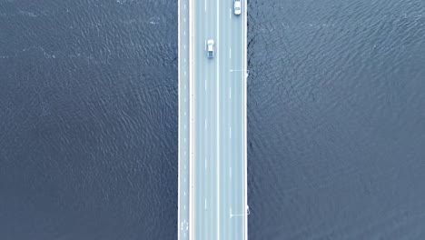Drone-aerial-view-of-cars-transport-on-freeway-highway-bridge-road-over-lake-Clyde-River-Batemans-Bay-South-Coast-travel-transport-Australia