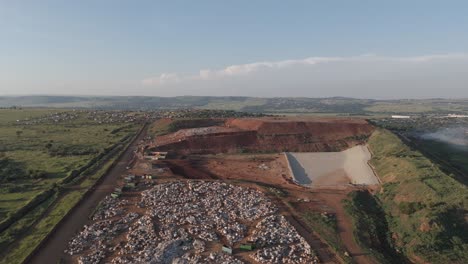 A-surveying-drone-shot-smoothly-turns-into-a-sizable-waste-processing-site-in-the-region-of-Pretoria,-South-Africa