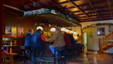 Mature-adults-and-senior-men-drinking-beer-in-a-German-bar-cafe-interior