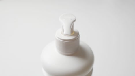 Man-applying-moisturizing-cream-on-his-palm-from-a-pump-dispenser