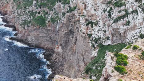 Scenic-Drone,-Backward-Camera,-Cap-Road-To-De-Formentor-Lighthouse-On-High-Rocky-Cliffs-In-Majorca