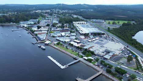 Drone-aerial-shot-of-Batemans-Bay-rural-town-main-centre-suburb-commercial-shops-street-on-river-architecture-South-Coast-tourism-Australia