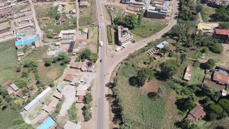 Road-traffic-on-road-in-Loitokitok-village,-Kenya,-aerial-view