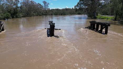 Drone-shot-pan-of-flooded-Goulburn-river-with-old-bridge