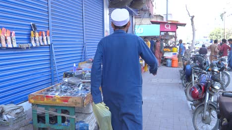 Cinematic-shot-of-small-roadside-stalls-near-in-Saddar-Bazar-Street-during-daytime-in-Karachi-,-Pakistan