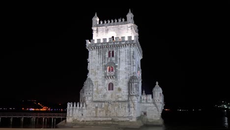Stunning-Belém-Tower,-medieval-defense-tower-from-side-view-at-night-in-Lisbon,-Portugal