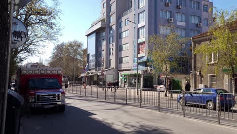 Light-traffic-passing-by-a-Ford-ambulance-parked-on-'Vasil-Aprilov''-Blvd