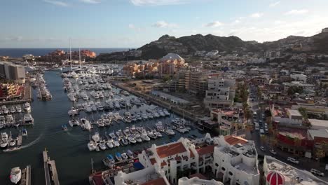 Establishing-shot-of-hundreds-of-boats-docked-at-a-marina-in-Cabo-San-Lucas,-Mexico---picturesque-aerial-parallax