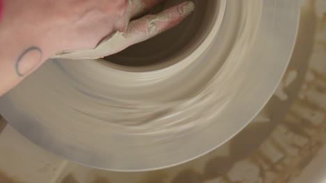 Potter-crafts-a-bowl-on-a-throwing-wheel-delicately