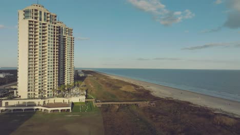An-aerial-establishing-shot-of-Palisade-Palms-Luxury-Residential-Condominiums-and-a-view-towards-East-Beach-and-the-Gulf-of-Mexico-on-Galveston-Island,-Texas