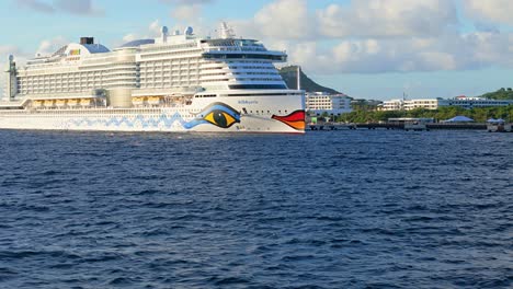 Large-cruise-ship-docked-in-Caribbean-tropical-island-port-on-sunny-day