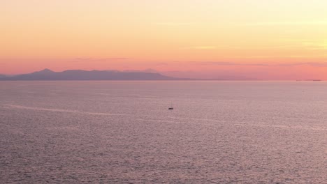 Drone-at-sunset-in-Flisvos-port-Athens-on-Aegean-Sea,-open-ocean-calm-water-scenic-seascape-of-European-capital