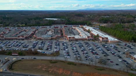 Aerial-view-showing-many-parking-cars-at-shopping-mall-in-America-during-sunny-day---Georgia,-USA
