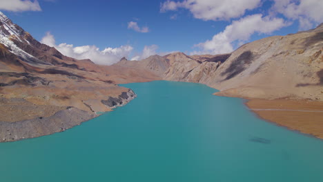 World's-Highest-altitude-lake-Tilicho-at-Nepal-landscape-hills-shooting-clouds-and-blue-aesthetics,-Manang-Annapurna-region-beauty-Tourism-4K