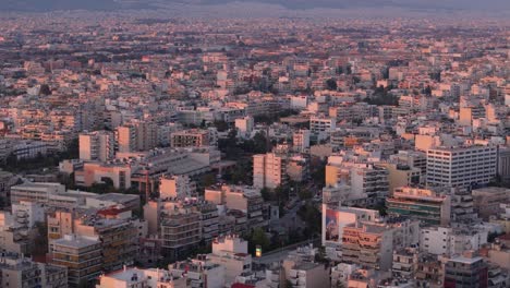 Aerial-of-Athens-cityscape-at-sunset,-skyline-skyscraper-building-urban-polluted-environment-of-smart-city-capital-of-Greece