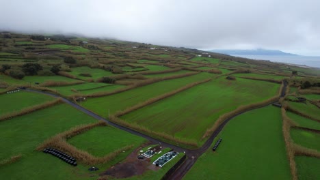 Aerial-of-green-patched-meadow-of-farming-land-in-Faial-on-cloudy-day