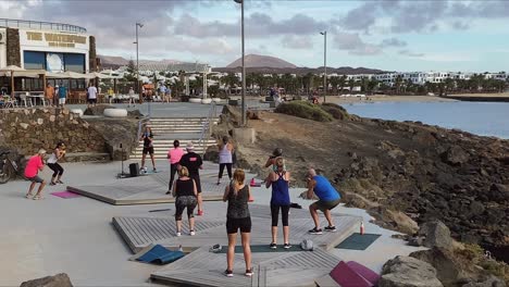 People-exercising-at-an-outdoor-class-on-the-seafront