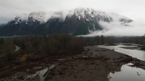 4K-drone-footage-forward-video-of-foggy-snowcapped-Mount-si-during-winter