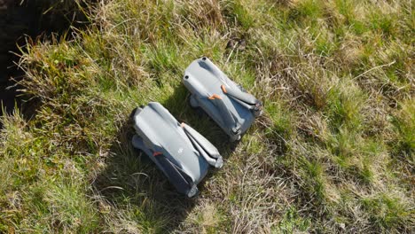 Overhead-View-of-Folded-DJI-Air-2S-And-Air-3-On-Grass-For-Side-By-Side-Comparison